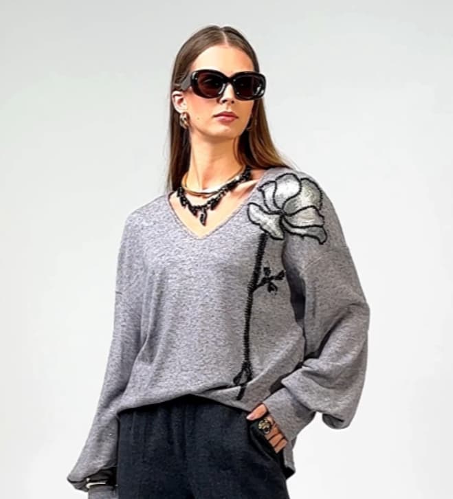 Knit sweater with decorative embellishment