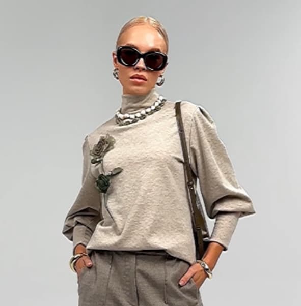 Beige knit sweater with decorative embellishment