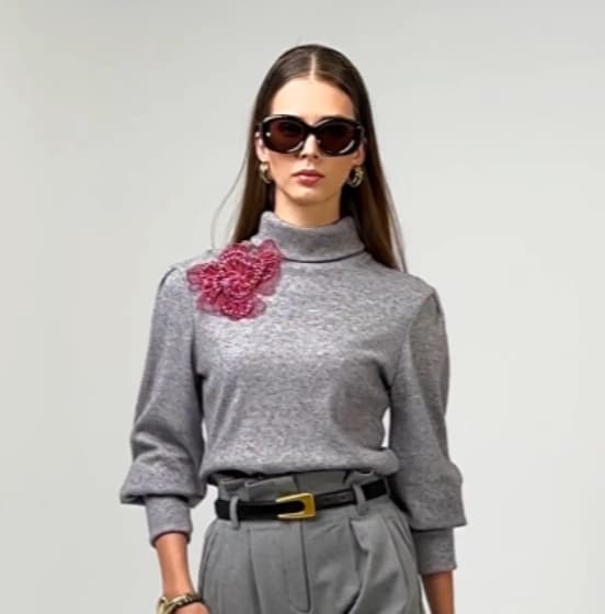 Grey knit sweater with decorative embellishment