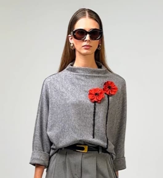 Textured grey sweater with decorative embellishment